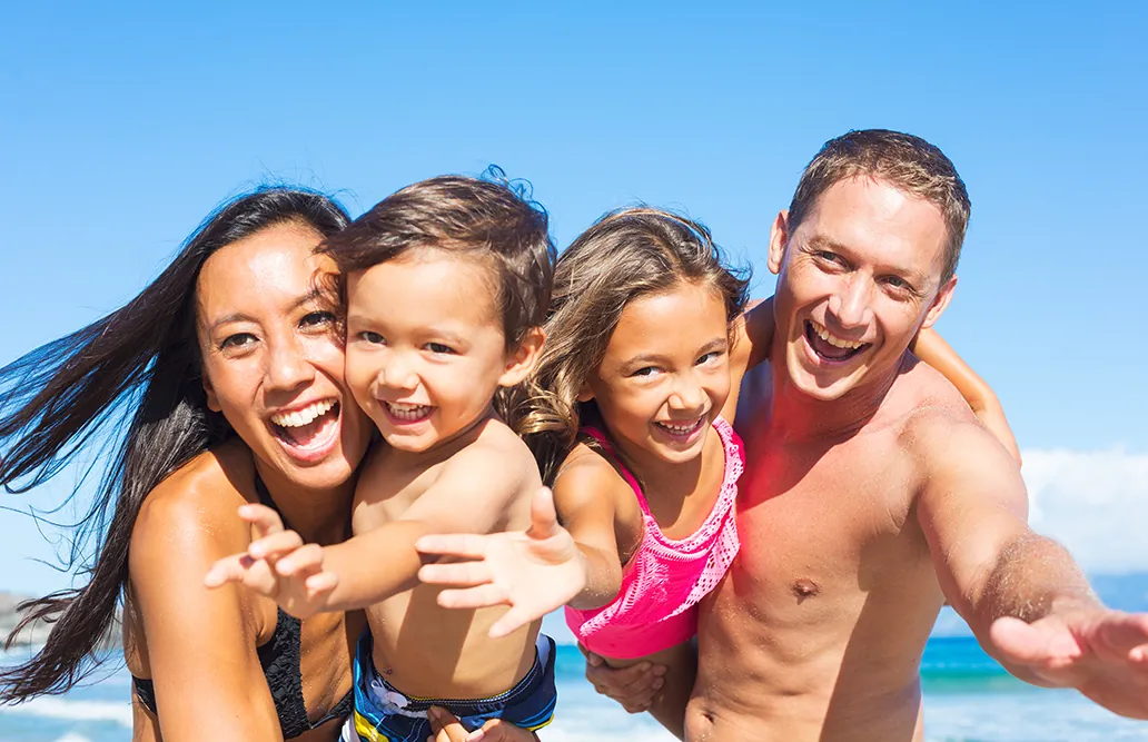 A family laughing together on an Australian beach