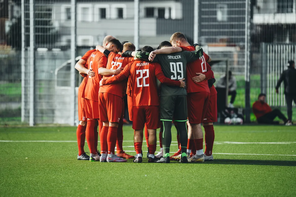 A football team huddled together in a team talk