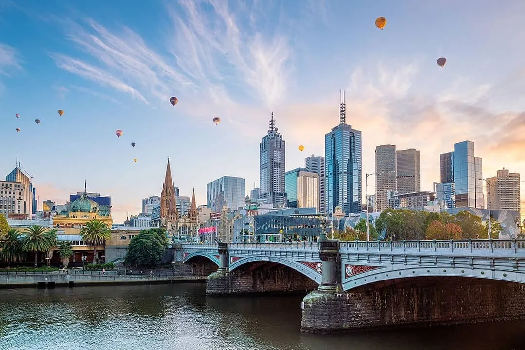 Melbourne's skyline by day with hot air balloons overhead