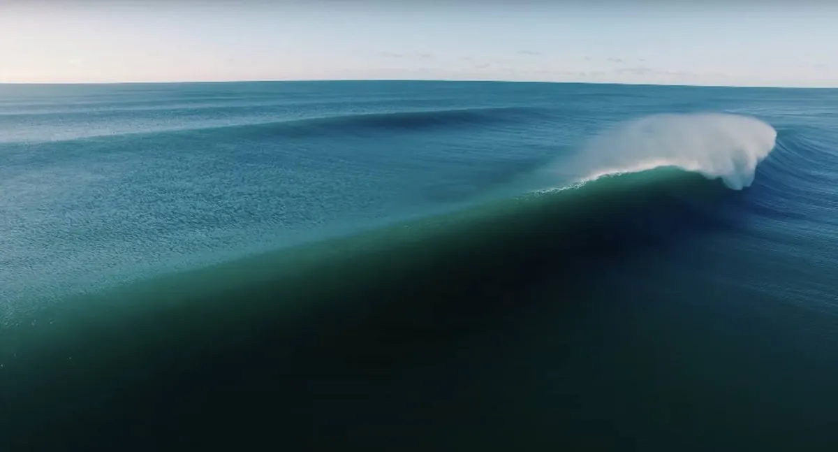 A wave curling along the coast