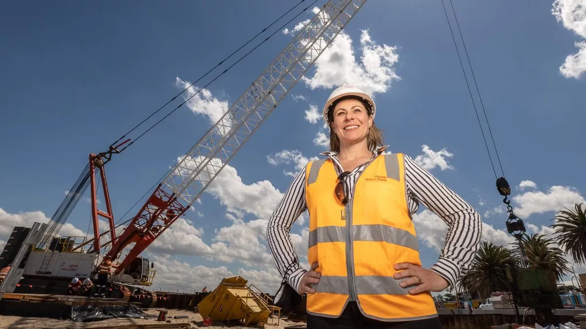 A construction professional in a hard hat and hi-vis vest on site